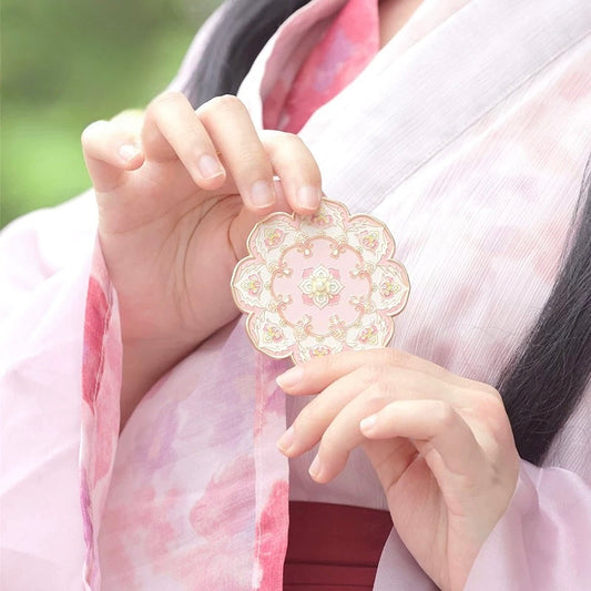 Dunhuang Blooms pocket mirror — floral cover artwork detail